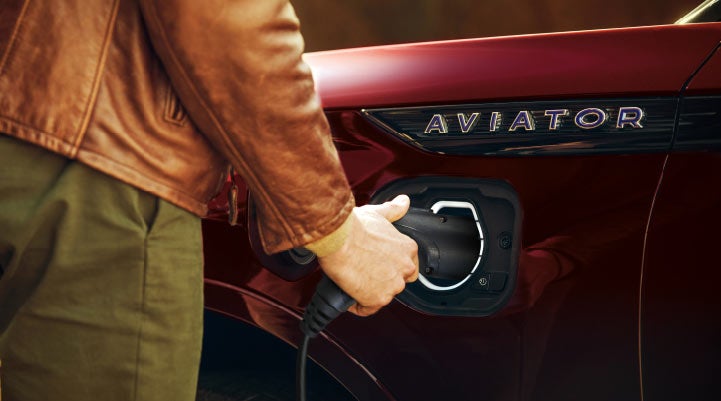 A hand is shown plugging in the charger into the charging port of a 2021 Lincoln Aviator | Courtesy Lincoln in Altoona PA