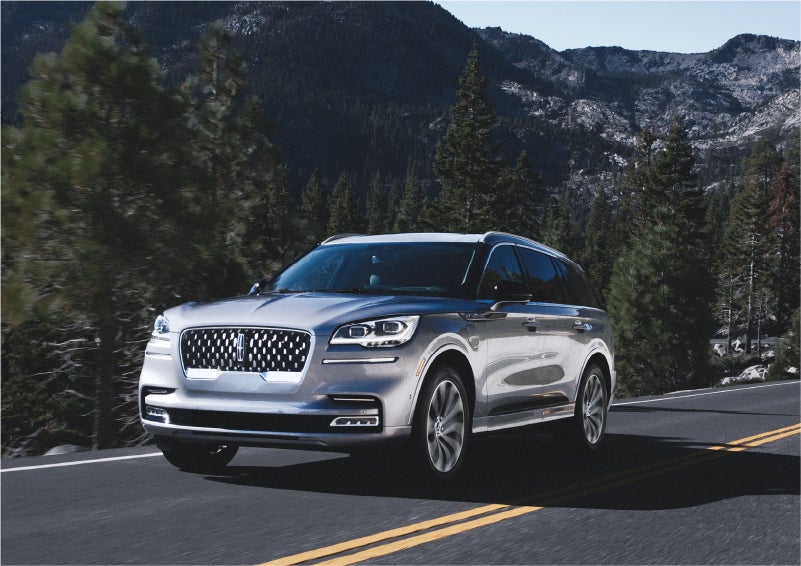 A 2023 Lincoln Aviator® Grand Touring SUV being driven on a winding road to demonstrate the capabilities of all-wheel drive | Courtesy Lincoln in Altoona PA