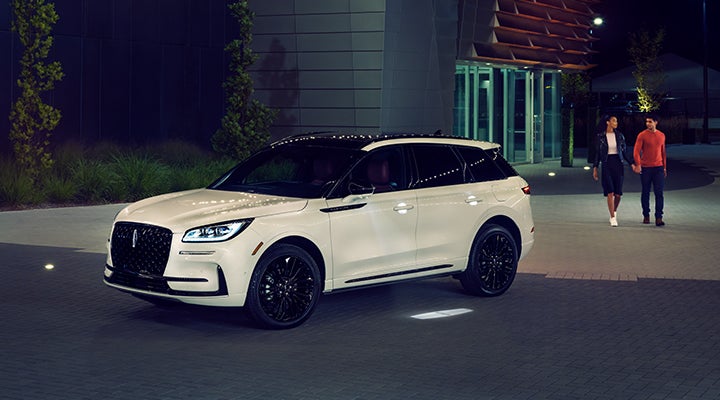 Two people approach a 2024 Lincoln Corsair® SUV featuring the available Jet Appearance Package. | Courtesy Lincoln in Altoona PA