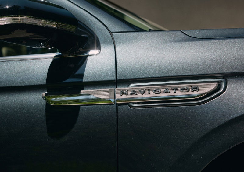 The nameplate badge near the passenger sideview mirror on a 2024 Lincoln Navigator® SUV shows off geometric design.