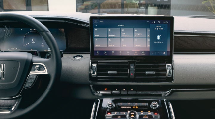 The front cabin of a 2024 Lincoln Navigator® SUV shows off ergonomic design and the 13.2-inch LCD center touchscreen displaying the SYNC® 4 interface.