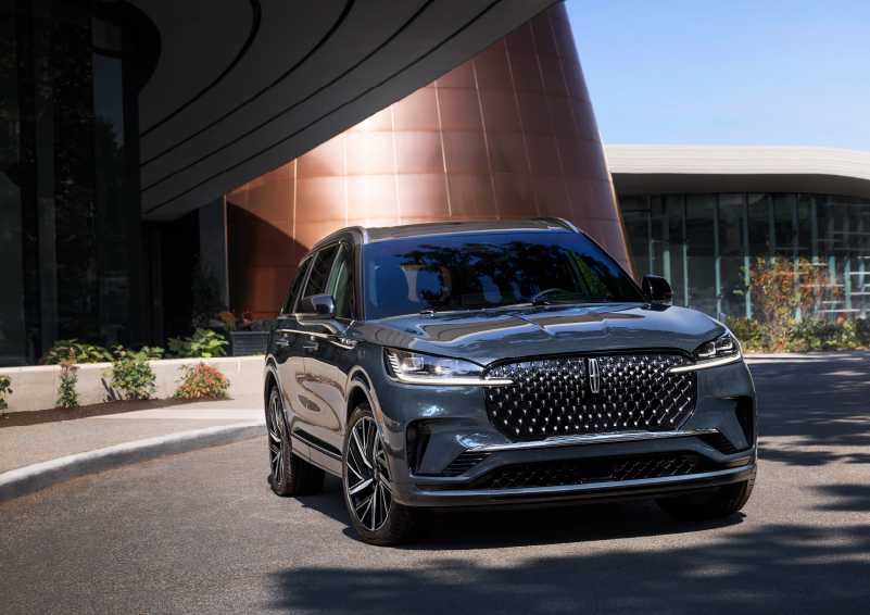 A gray 2025 Lincoln Aviator® SUV is parked outside a modern building with the sun shining. | Courtesy Lincoln in Altoona PA