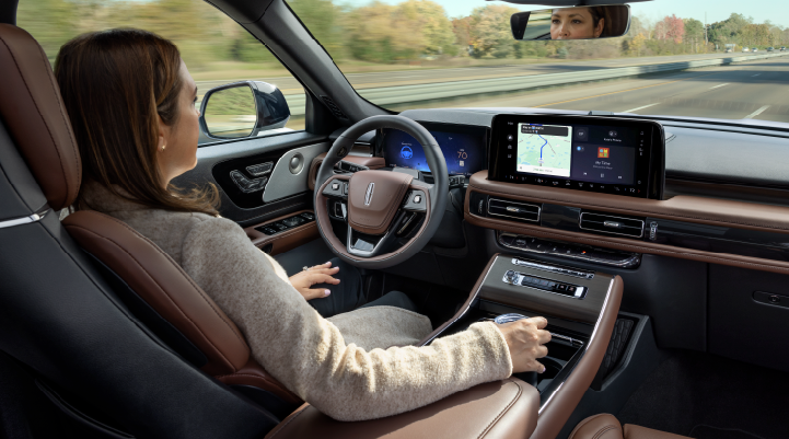 A woman is seen sitting in the driver’s seat of her 2025 Lincoln Aviator® SUV with her hands off the steering wheel. | Courtesy Lincoln in Altoona PA