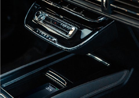 A smartphone rests on the available wireless charging pad in the front center console cubby | Courtesy Lincoln in Altoona PA