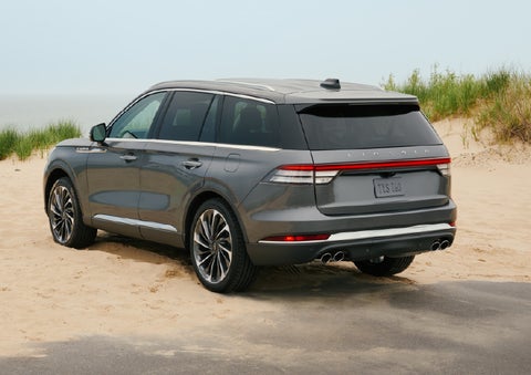 A 2027 Lincoln Aviator® SUV is parked next to sand dunes. | Courtesy Lincoln in Altoona PA