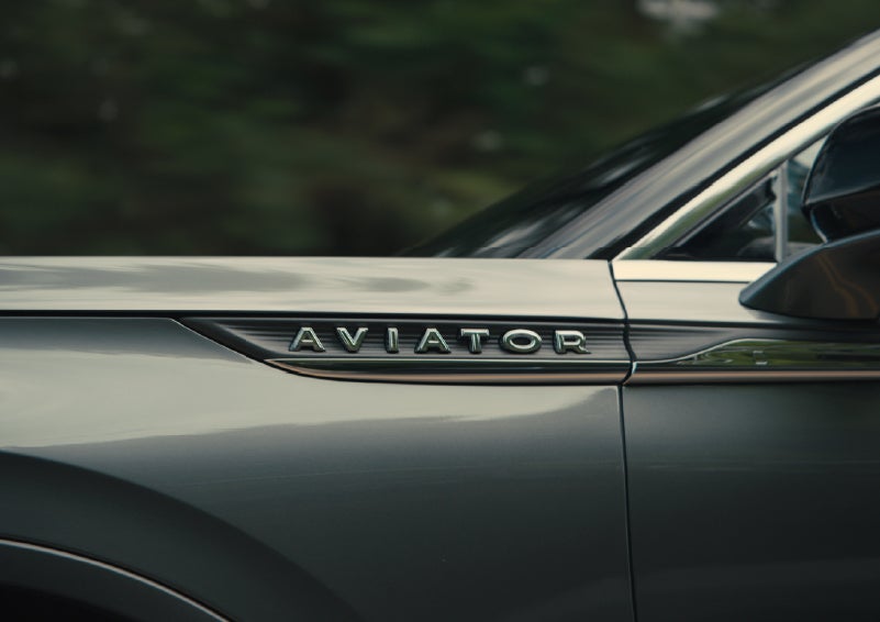The driver’s side door and fender badging of a gray 2027 Lincoln Aviator® SUV are showcased. | Courtesy Lincoln in Altoona PA