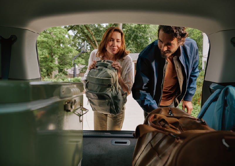 A couple loads luggage into the rear of a 2027 Lincoln Aviator® Black Label™ SUV..e 202 | Courtesy Lincoln in Altoona PA