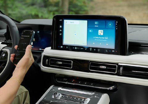 A person pairs thier phone with the center touchscreen of a 2027 Lincoln Aviator® Black Label™ SUV | Courtesy Lincoln in Altoona PA